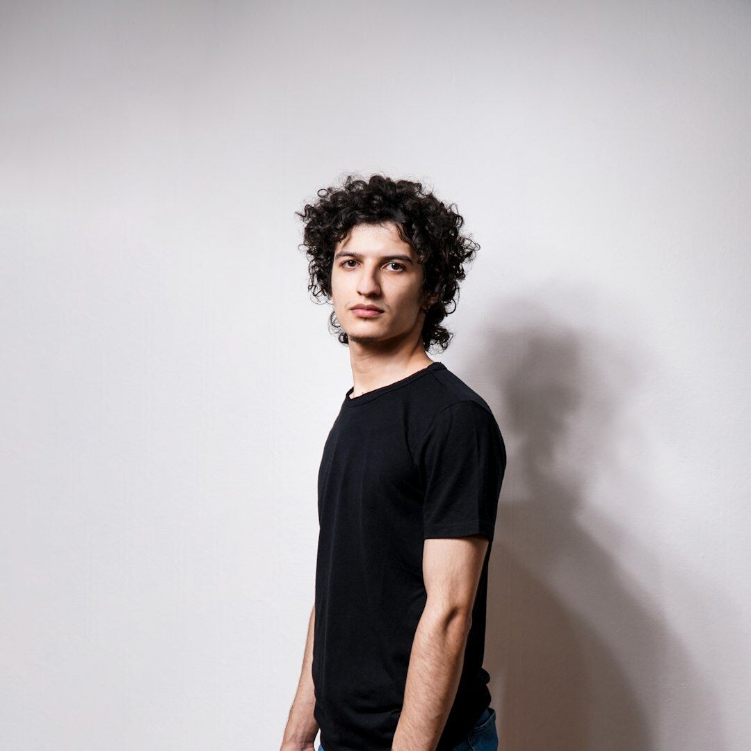 Portrait of a smiling young man with curly hair