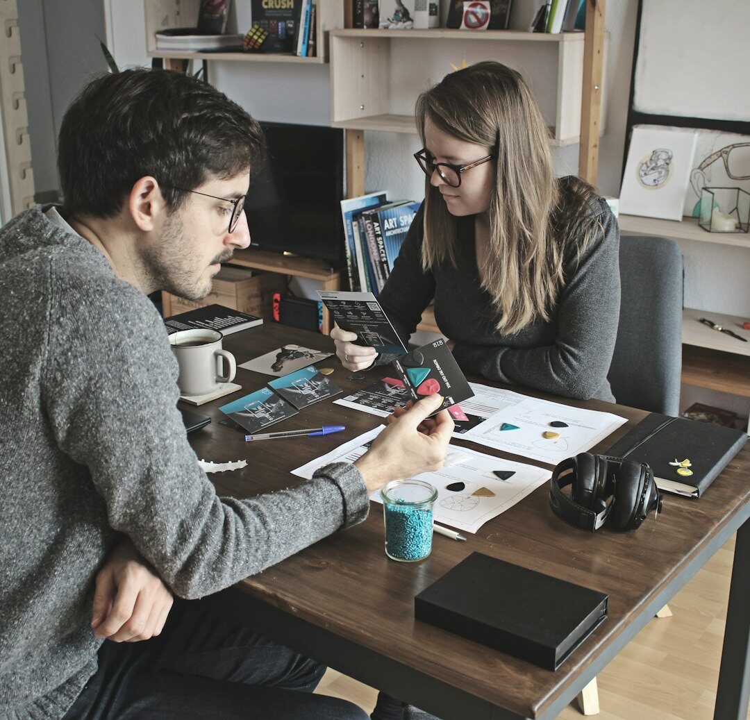Two colleagues laughing together while working